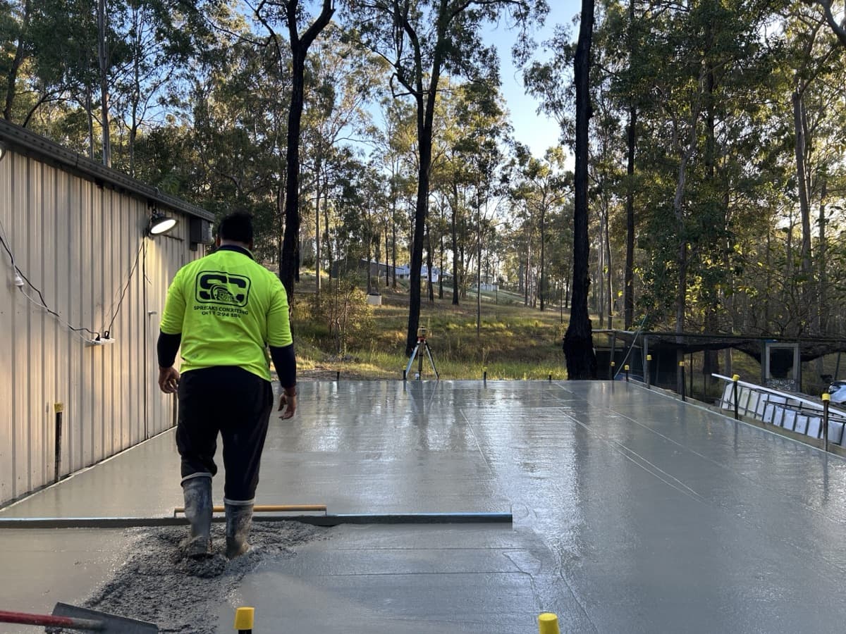 Concreter screeding a freshly poured slab
